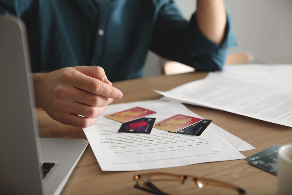 person-with-multiple-credit-cards-dealing-with-debt