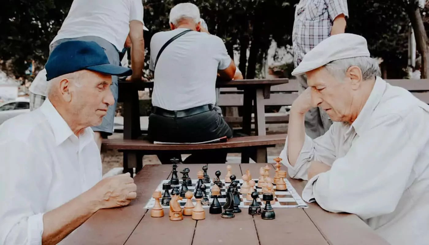 elderly men playing chess